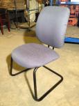 Used Guest chair with blue textured fabric and black frame 