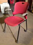 Used Rolling side chair with maroon plastic seat and grey arms 