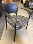 Used Guest chair with black frame and brown and tan pattern 