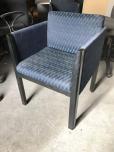 Used Reception chair with blueish green fabric pattern and black wood frame 