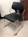 Used Stacking chairs with black seat and chrome frame 