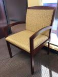 Used Guest chair with yellow patterned fabric and mahogany frame 